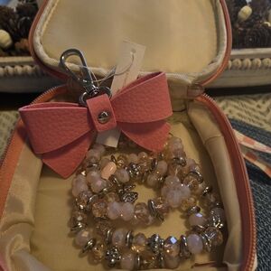 Small Travel Case With Coil Bracelet And Pink Bow Keychain